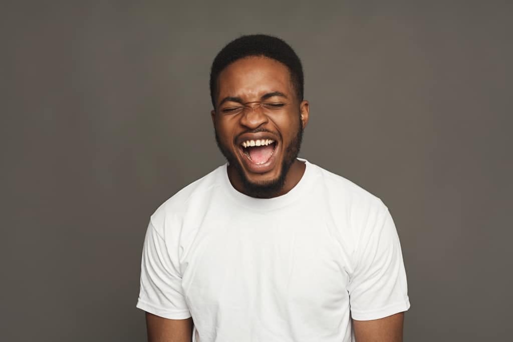 Hypnotherapy for anger Man shouting with his mouth wide open