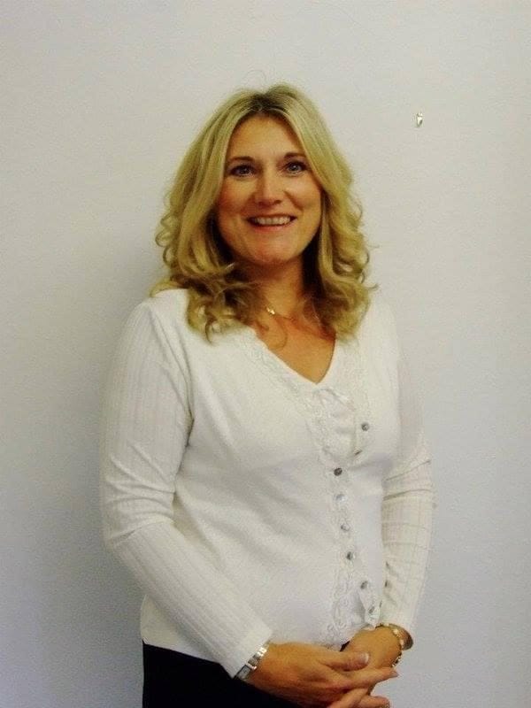 Sonya Hudson in a white cardigan, smiling